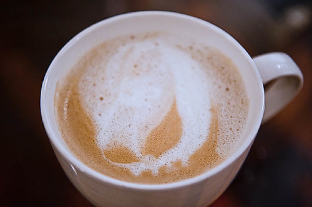 A beautifully crafted latte in a cozy cafe setting