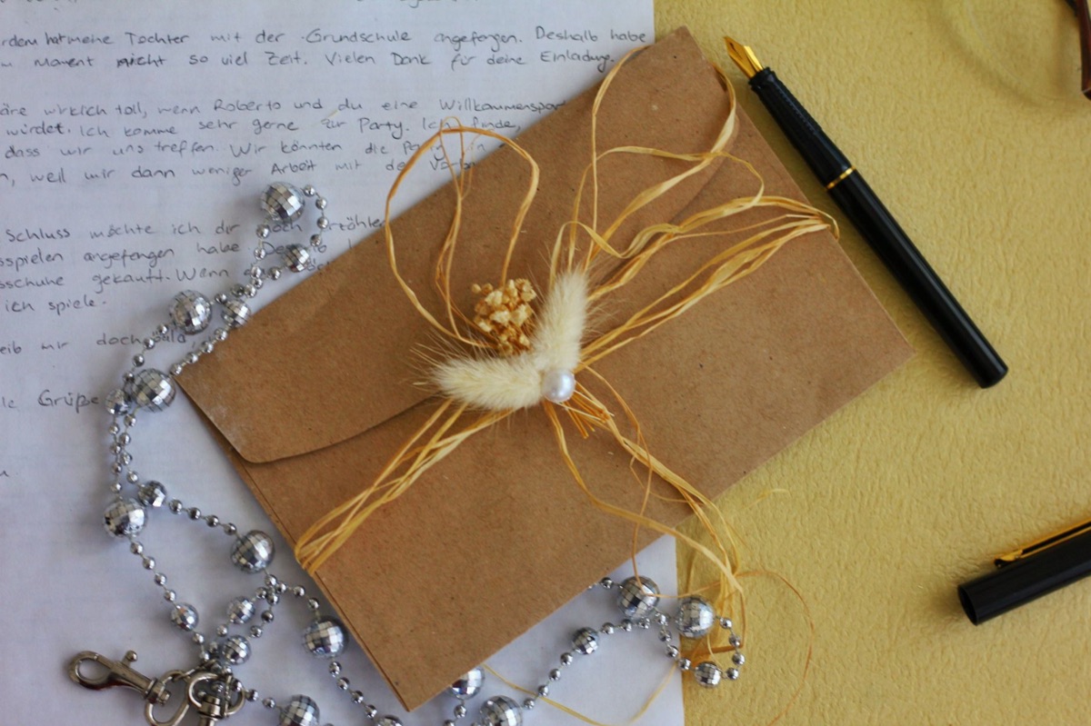 A handwritten letter and a vintage fountain pen on a desk representing sincere communication.