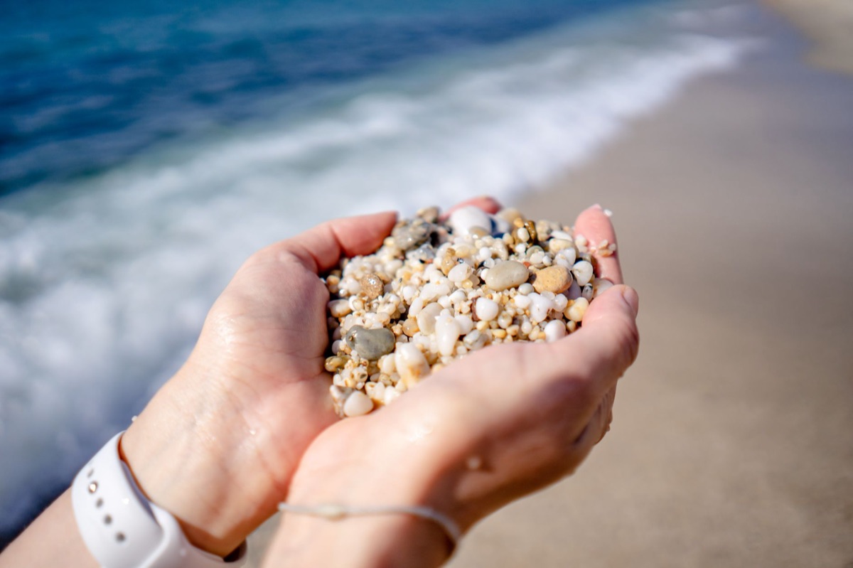 Hands carefully holding small, worn stones, symbolizing mutual acknowledgment.