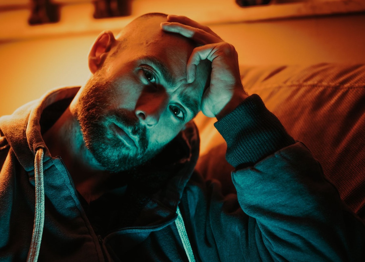 Person looking at hands in reflective mood