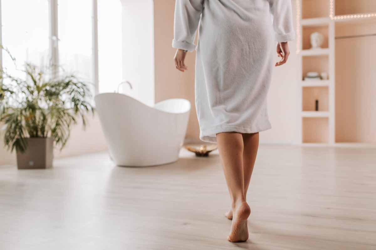 person in robe on wooden floor