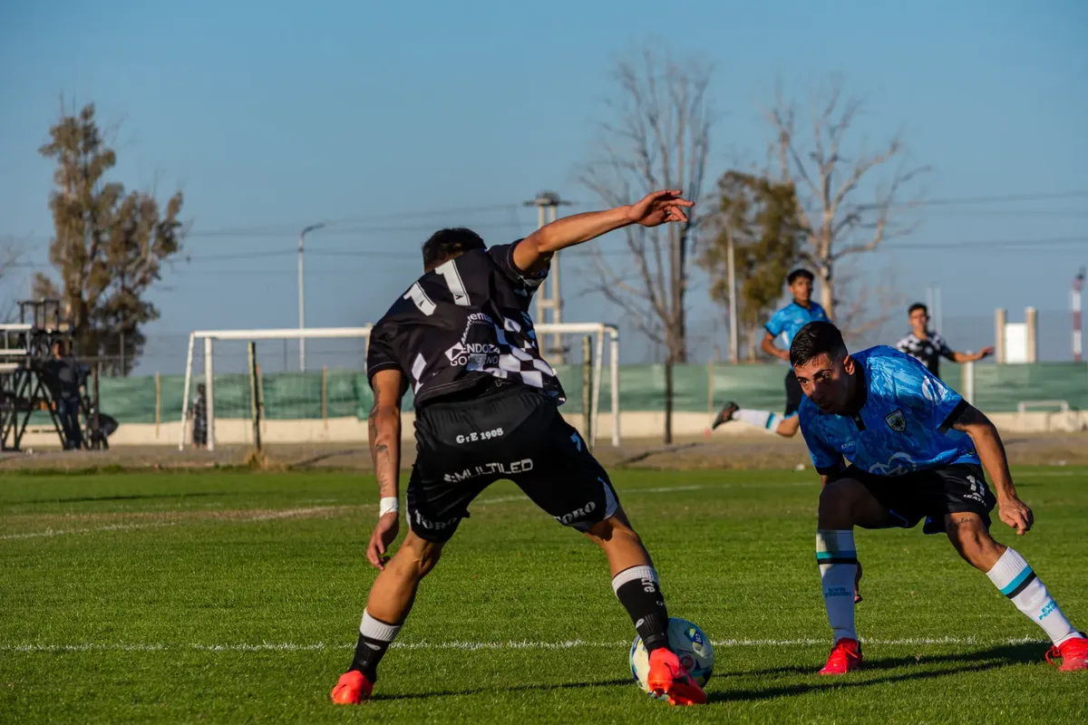 Captured intense moment during a soccer match under clear skies.